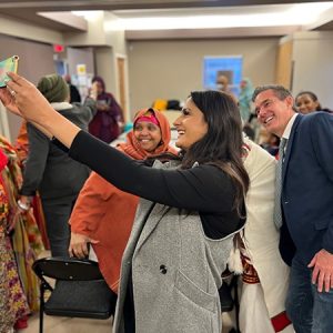 Minister Khera taking a selfie with members of the African Family Revival Organization.